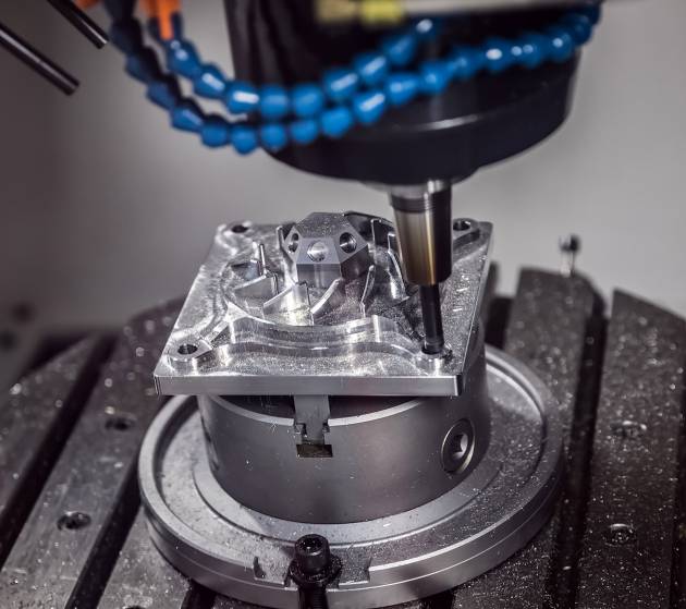Metalworking CNC milling machine. Cutting metal modern processing technology. Small depth of field. Warning - authentic shooting in challenging conditions. A little bit grain and maybe blurred.